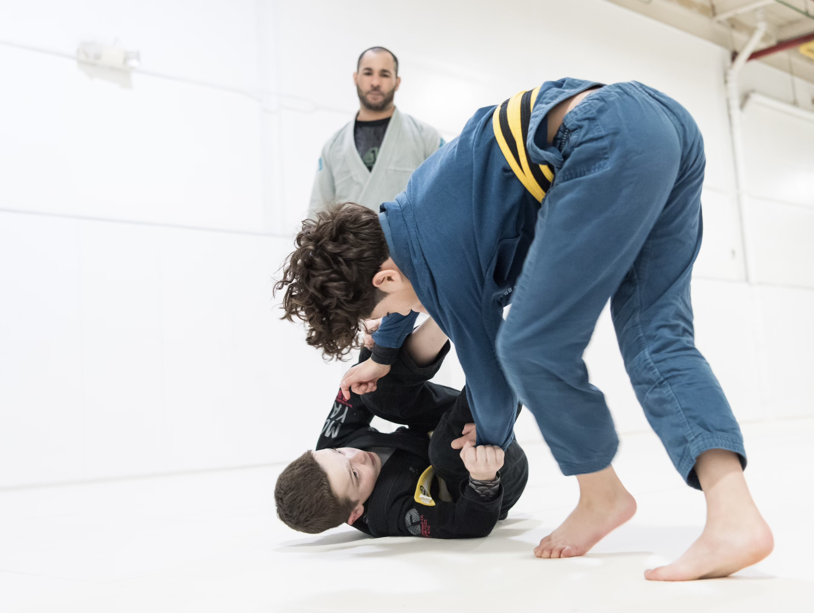 Kids Jiu-Jitsu class at Prodigy with coach supervising rolling